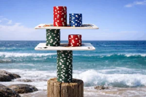 Coastal scene with poker chips stacked on playing cards in a delicate balance.