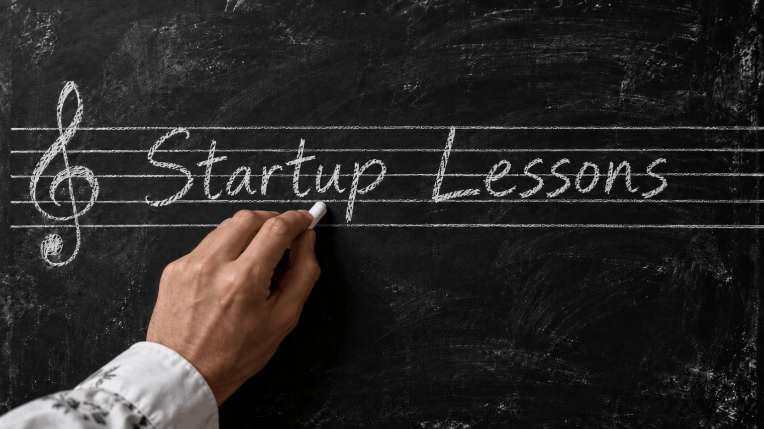 Chalkboard with Startup Lessons caption written across musical staff lines.