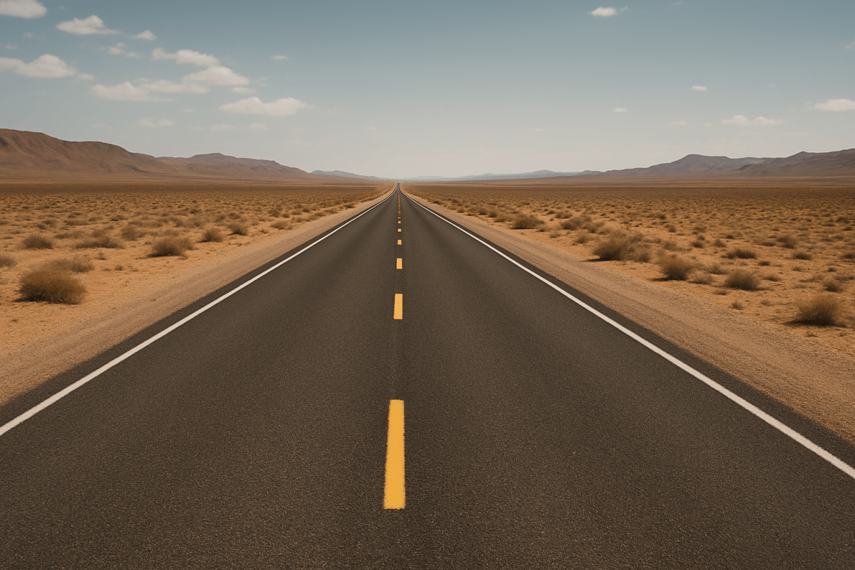Empty straight highway stretching into desert horizon